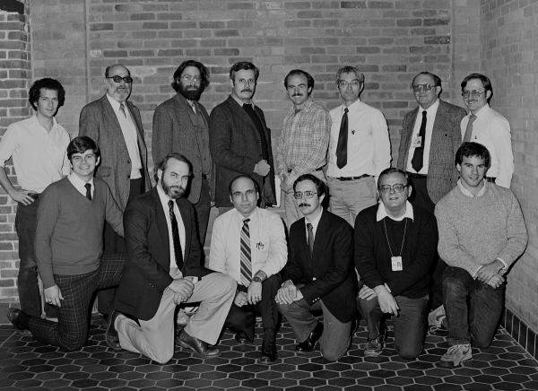Group shot of Draper engineers including Lance Drane (front row, second from left), Rick Metzinger (back row third from right), Hal Laning (back row second from right), and others.