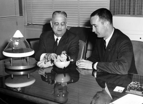 Dr. Draper and James McDivitt with the Nose Cone of the Service Module Dr. Draper and James McDivitt with the Nose Cone of the Service Module