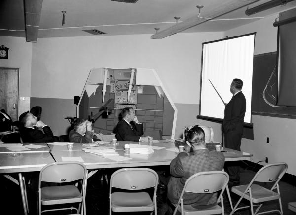 Astronauts and Engineers with Primary Guidance, Navigation, and Control System Mock-Up Astronauts and Engineers with Primary Guidance, Navigation, and Control System Mock-Up