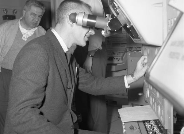 Astronaut Testing the Primary Guidance, Navigation, and Control System Simulator 