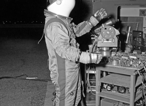 Astronaut in Spacesuit Testing Relief Optics for Apollo Guidance & Navigation System Astronaut in Spacesuit Testing Relief Optics for Apollo Guidance & Navigation System